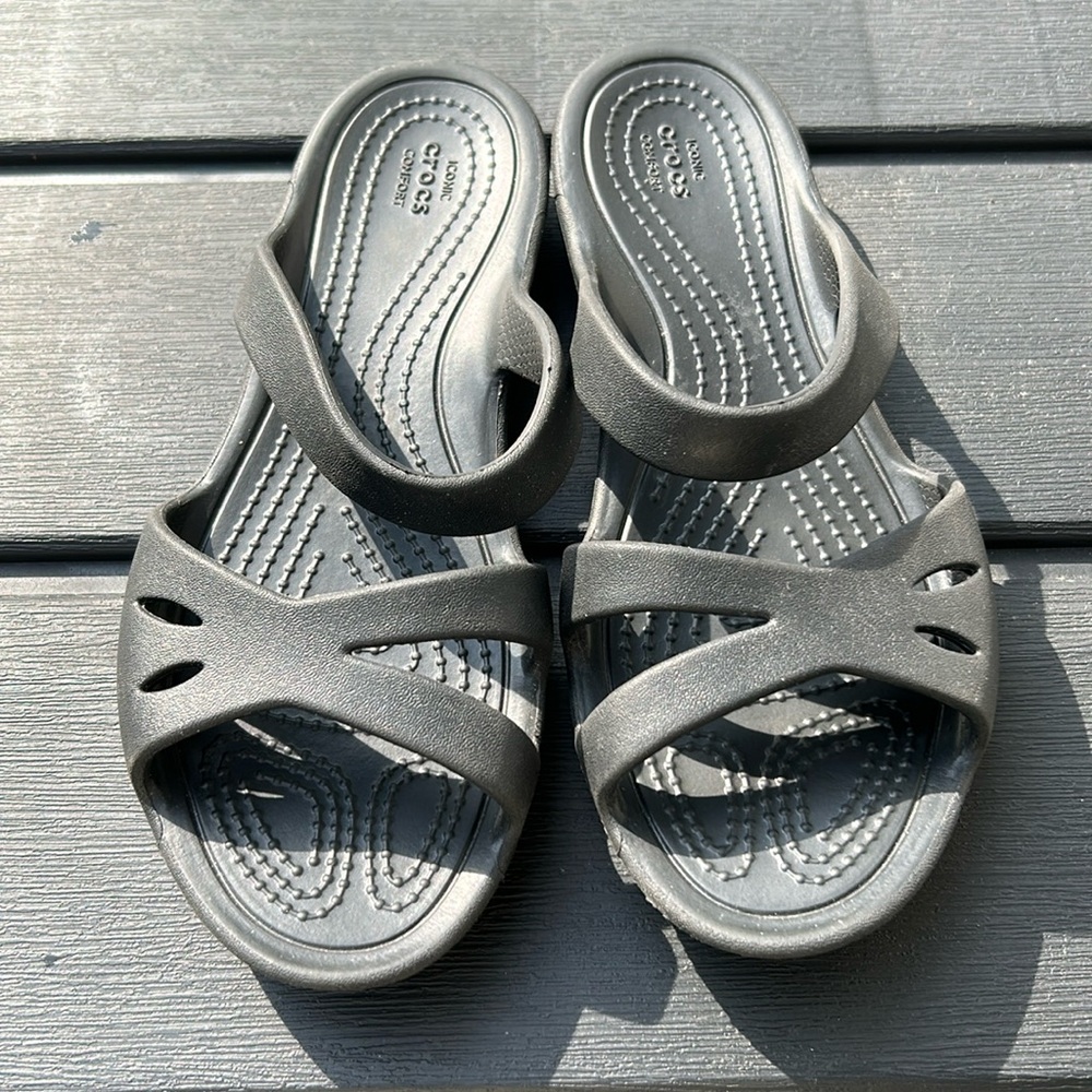 Black slide crocs, marked as size W 4, but fits like a child size 2
